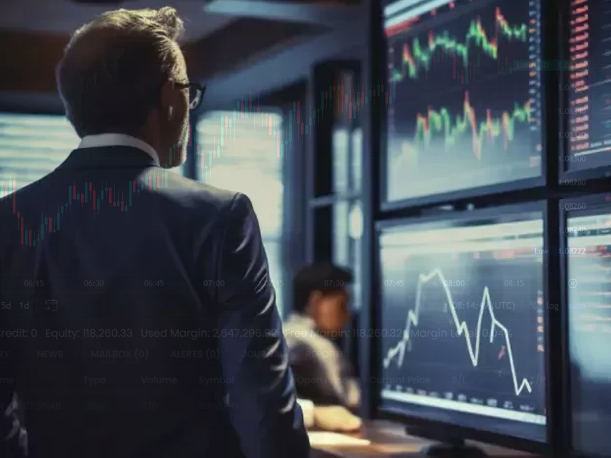 man looking at screens - Best Remote Prop Trading Firms