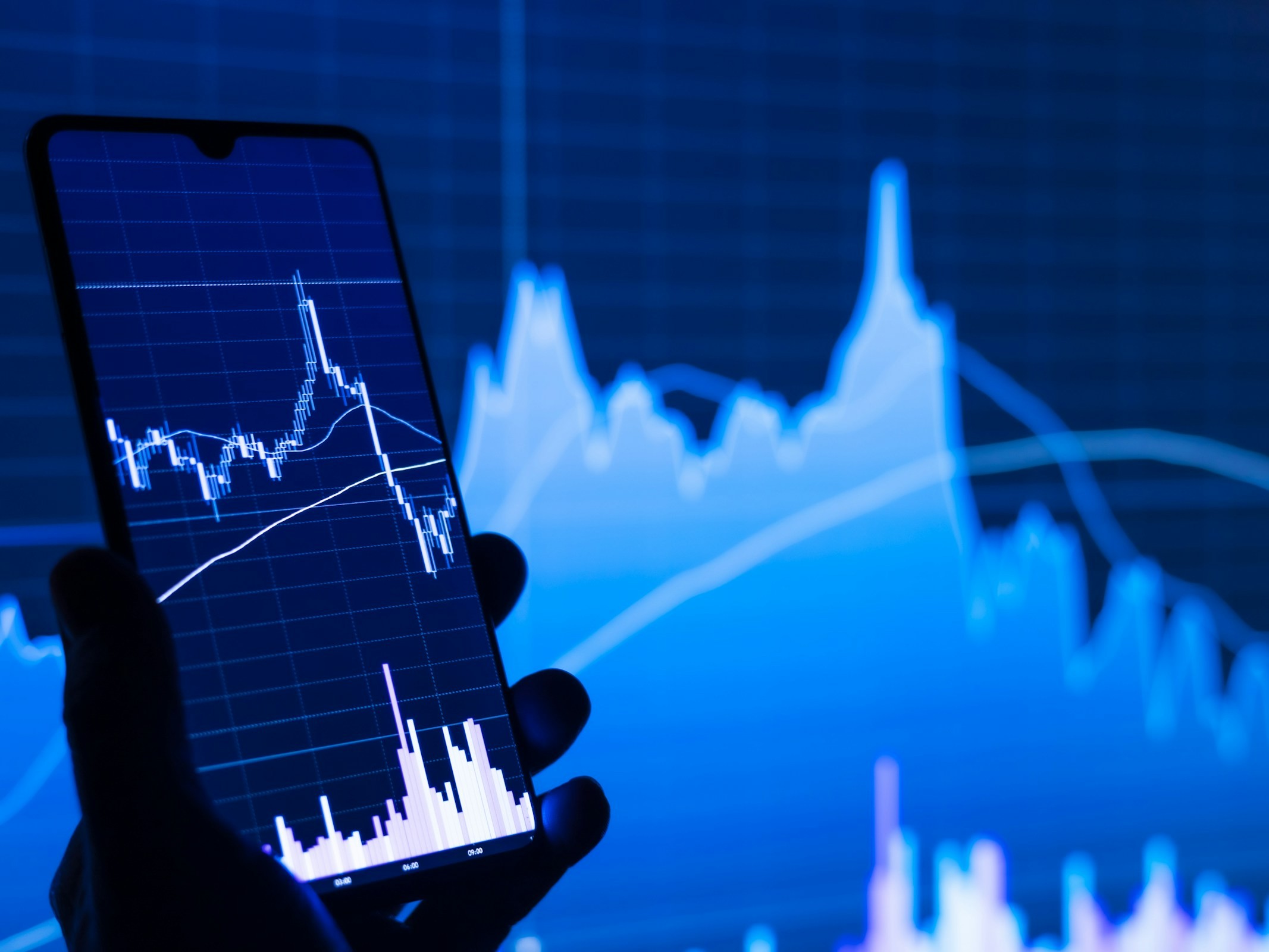 man holding a mobile - Prop Firms With No Time Limit