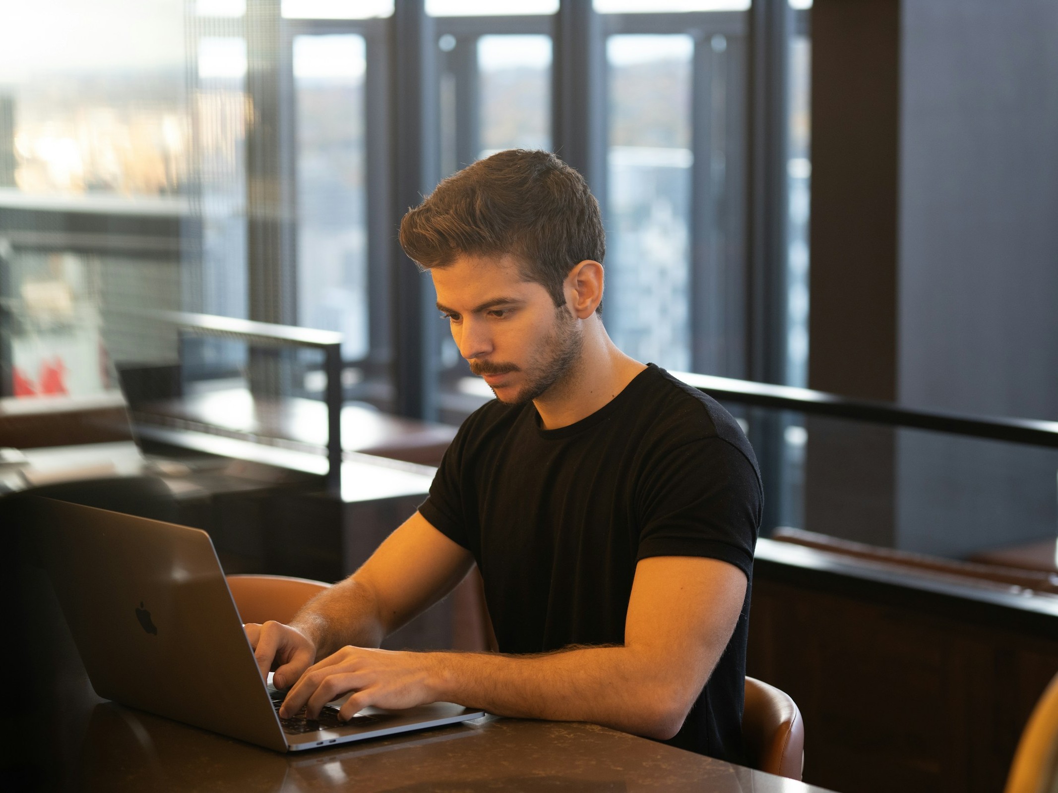 Man Working on Laptop - Which Prop Firms Have the Lowest Challenge Fees?