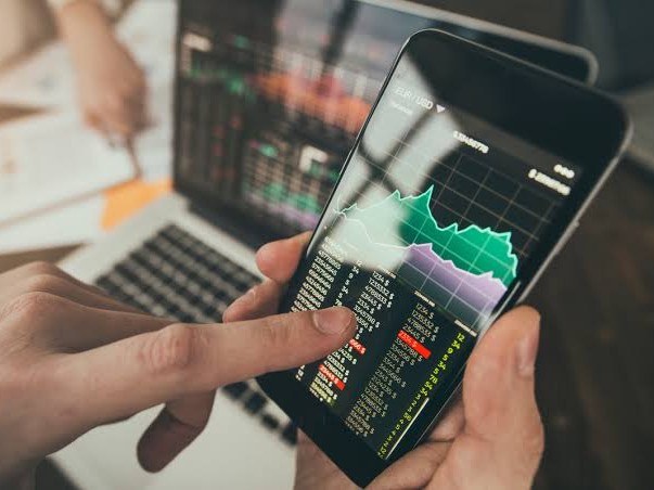 man looking at mobile - Best Time Frame for Crypto Trading