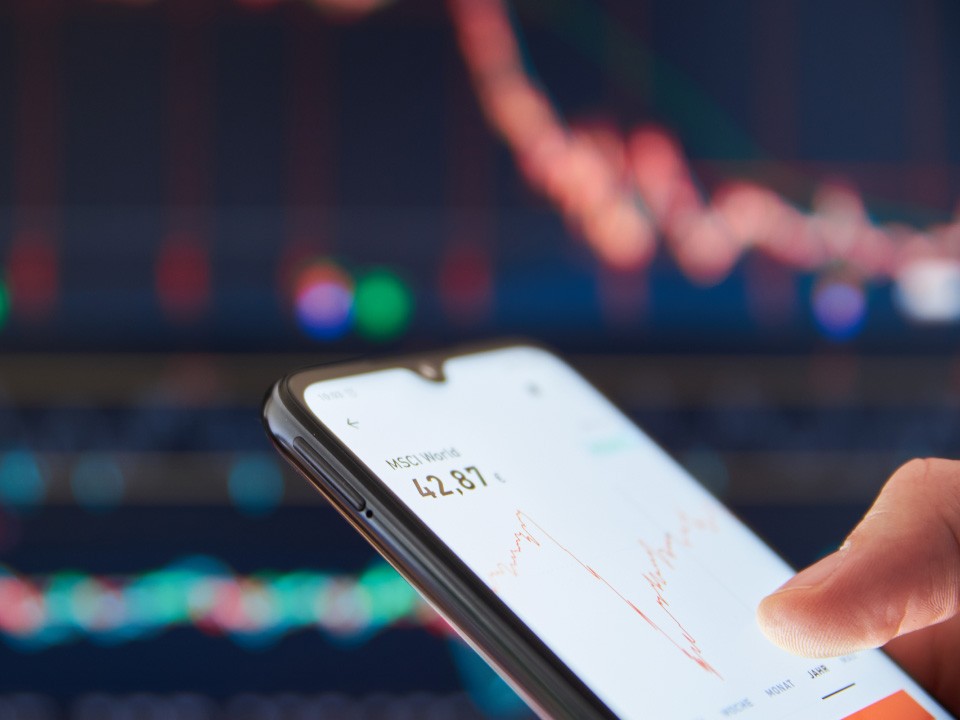man checking trades - Trading Goals for Beginners
